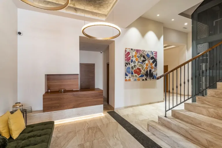 Vestíbulo moderno con escalera y arte mural