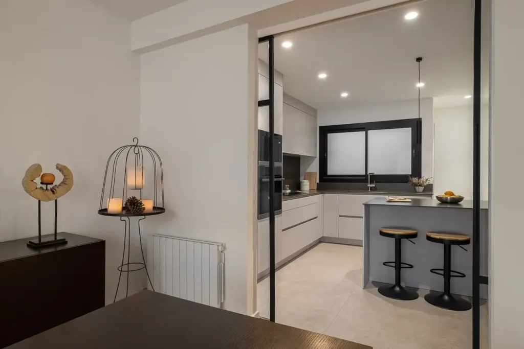 cocina moderna vista desde el salon con mesas y sillas