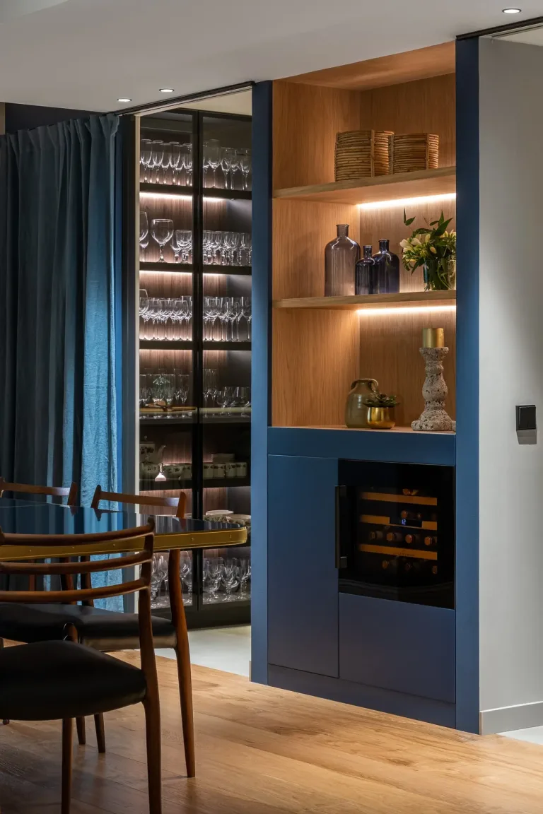 Un diseno elegante de sala con detalles en madera y una vinera iluminada