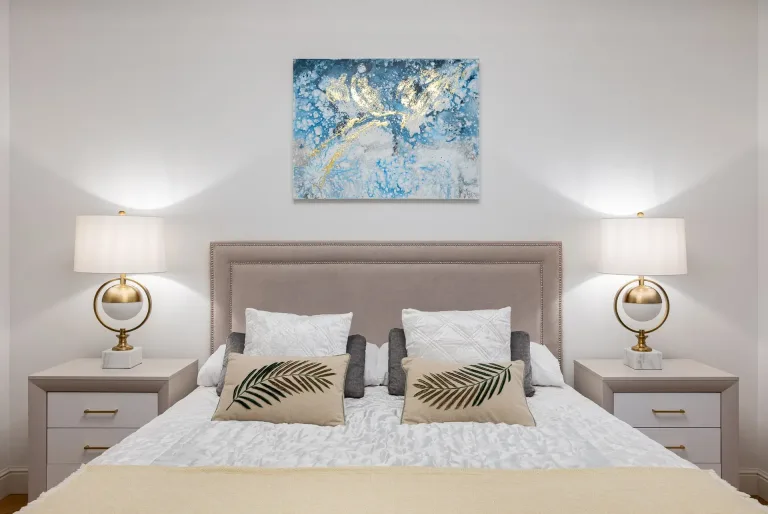 there is a bed with a white comforter and two lamps on either side of it an estate agent listing photo interior design 