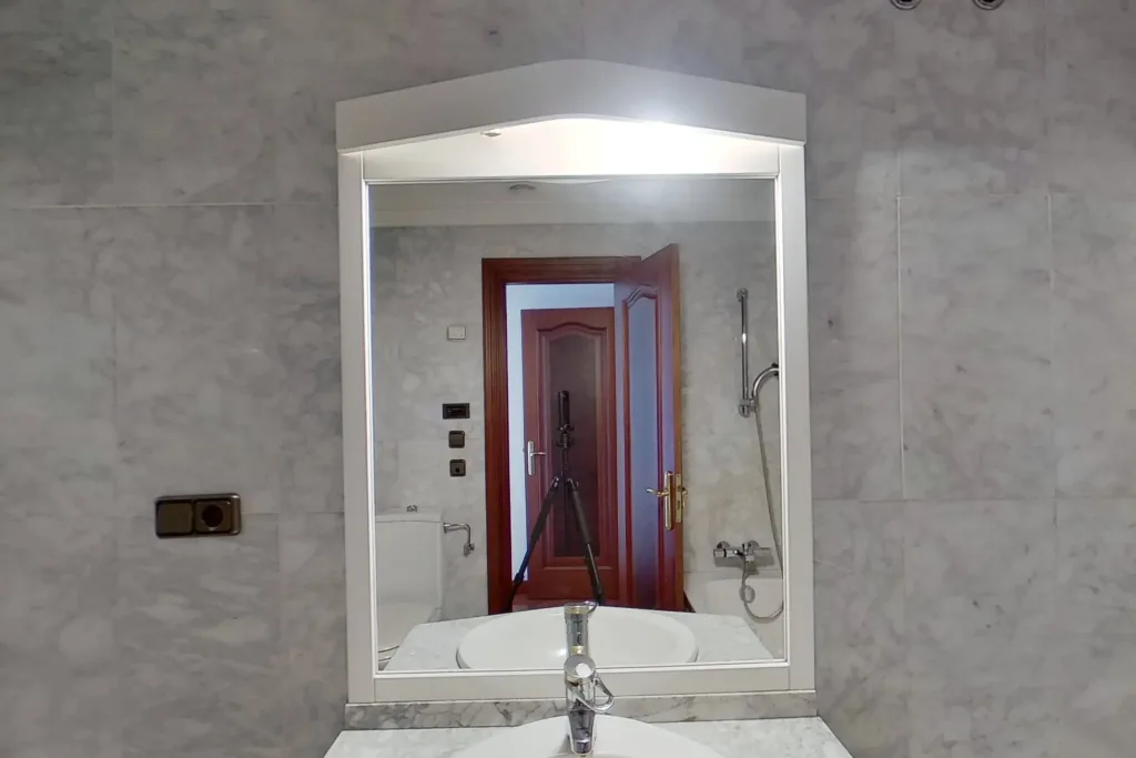espejo con reflejo de puerta y accesorios de bano