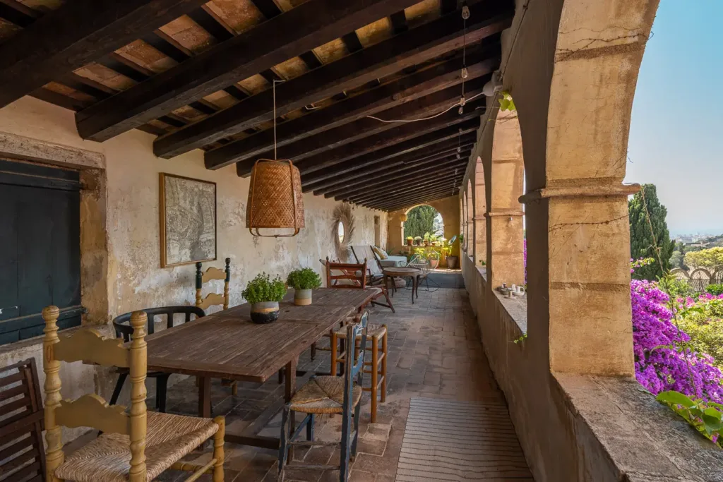 comedor al aire libre en un pasillo rústico con vigas de madera
