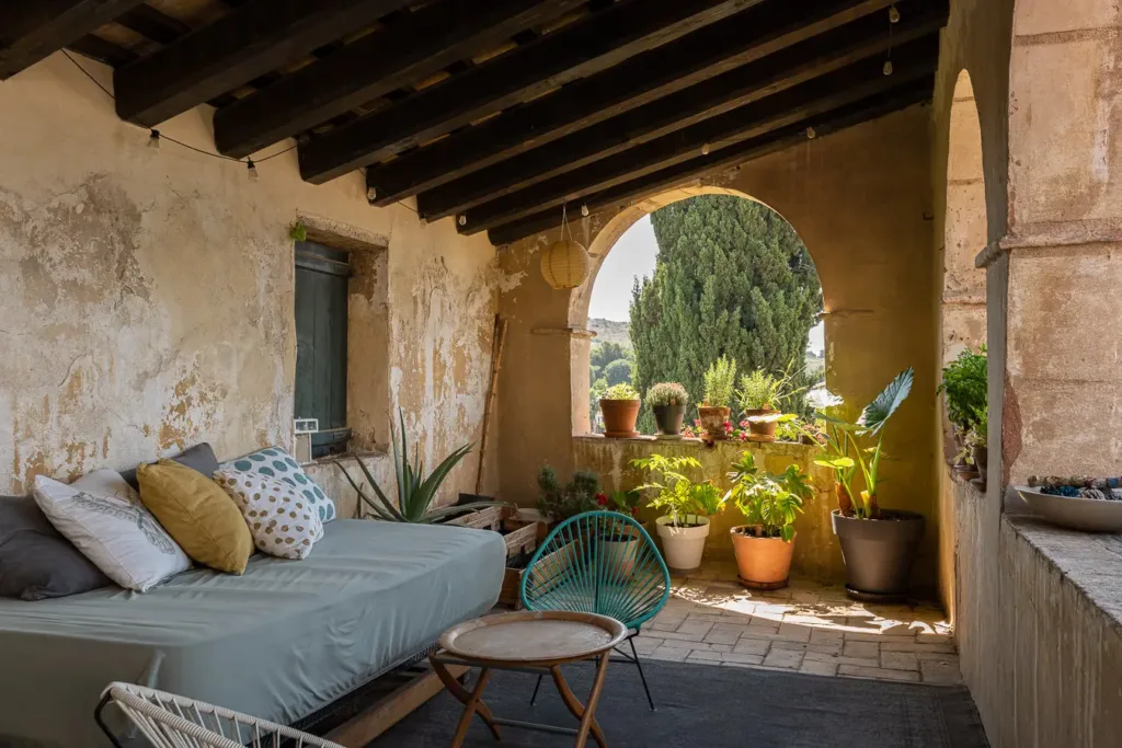 zona de descanso en un porche con plantas y vistas al exterior