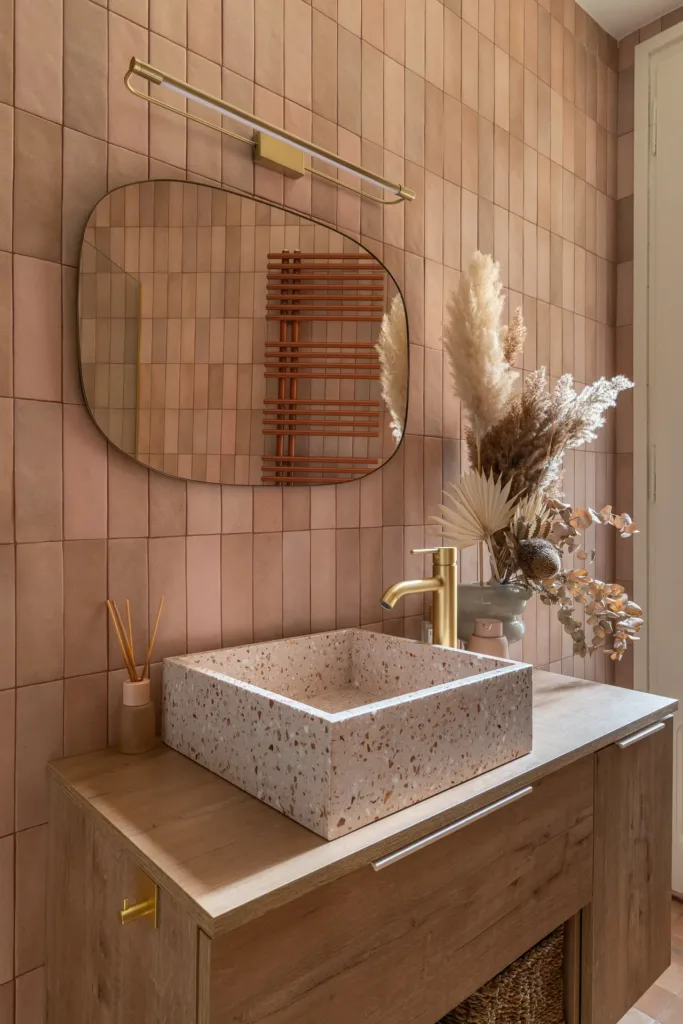 lavabo de baño con pared de azulejos terrosos