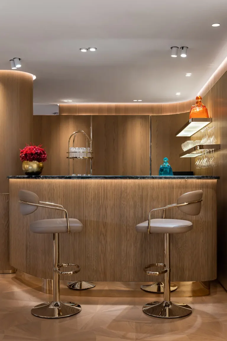 barra privada boutique madera taburetes dorados iluminacion calida