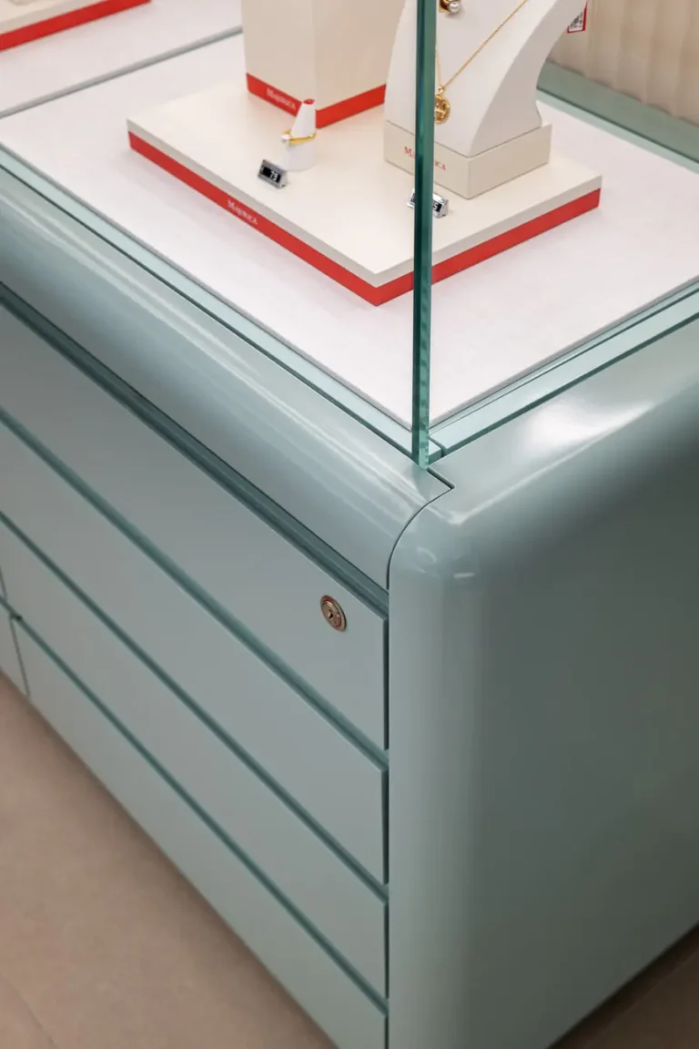 detalle de mueble vitrina con acabado en verde y cristal