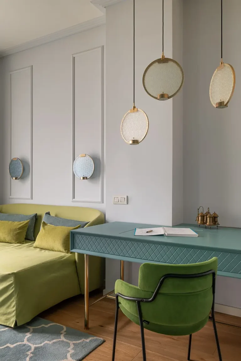 escritorio moderno con lámparas colgantes y sofá verde en salón elegante