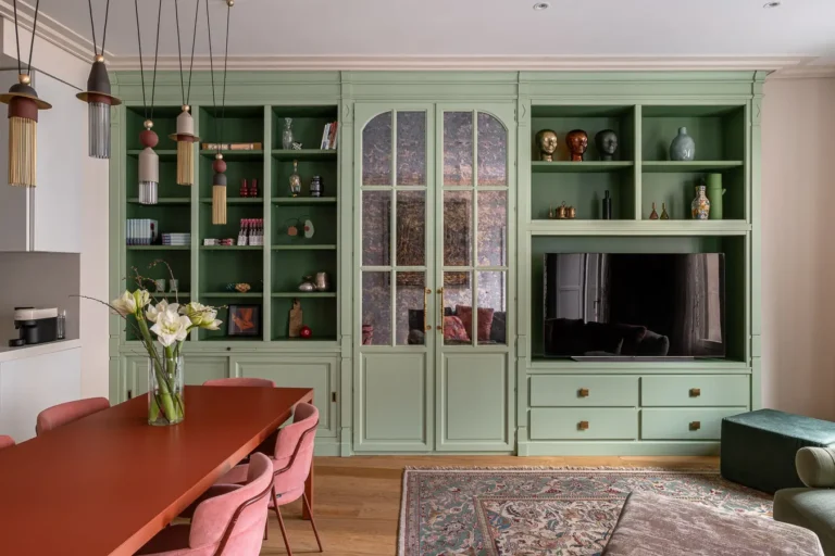salón con mueble verde empotrado y televisión integrada