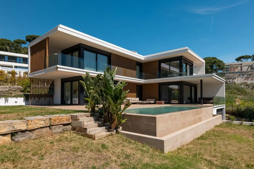 fachada principal con piscina elevada y palmeras
