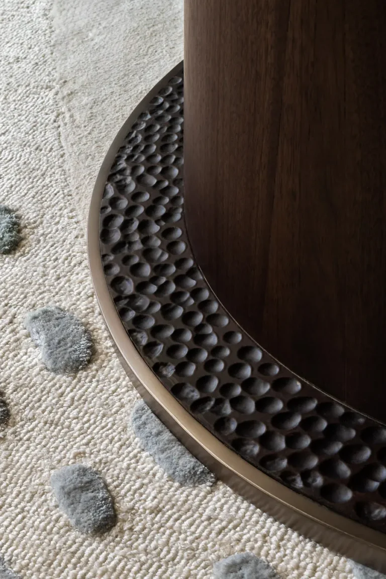detalle de base circular de mesa sobre alfombra en habitacion de hotel